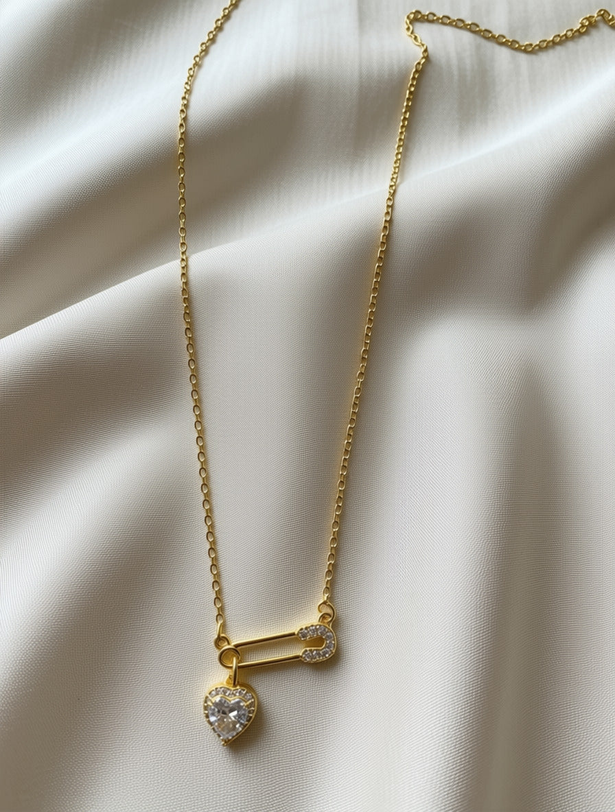 Loulu sparkling heart safety pin necklace.